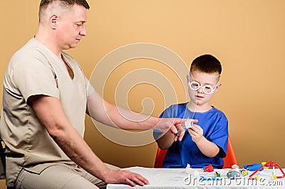 First aid. Medical help. Trauma and injurie. Medicine concept. Kid little doctor sit table medical tools. Health care Stock Photo