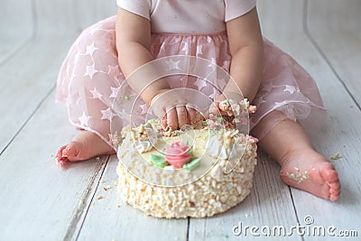 First baby birthday. Balloon garland on background. Disgruntled kid Stock Photo