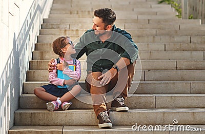 First day at school. father leads little child school girl in f Stock Photo