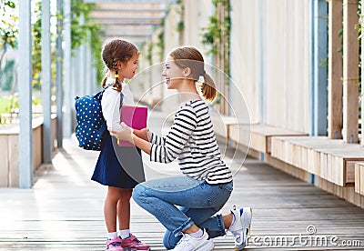 First day at school. mother leads little child school girl in f Stock Photo