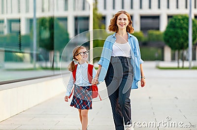 First day at school. mother leads little child girl in grade Stock Photo
