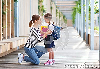 First day at school. mother leads little child school girl in f Stock Photo