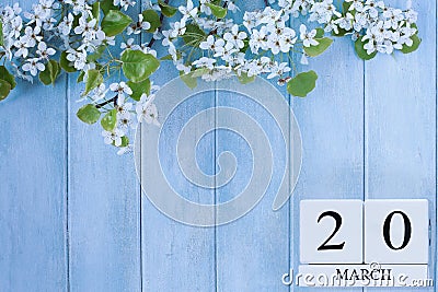 First Day of Spring Calendar with Blossoms against a Blue Background Stock Photo