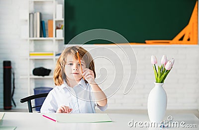 First grade. Kid studying at school. Schoolchild doing homework at classroom. Education for kids. Stock Photo