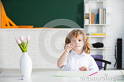 First grade. Kid studying at school. Schoolchild doing homework at classroom. Education for kids. Stock Photo