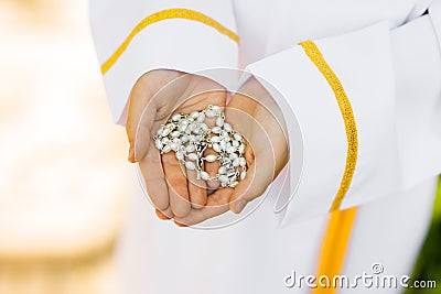 First Holy Communion. A child holding a rosary Stock Photo