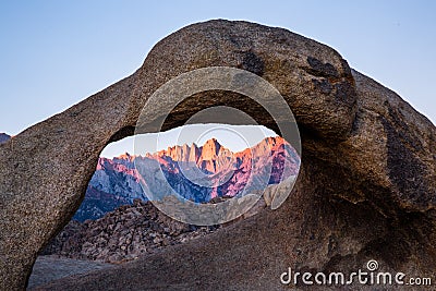 First light of the sunrise on Mount Whitney looking through Mobius Arch in the Alabama Hills Stock Photo