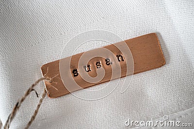 First name Susan identity engraved name dog tag copper metal name plate Stock Photo