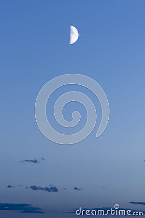 Half moon against the background of the night blue sky with dark clouds, abstract background Stock Photo