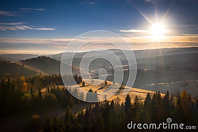 The first rays of the rising sun over the autumnal Tatra Mountains. The pass over Lapszanka. Poland Stock Photo