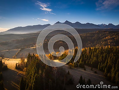 The first rays of the rising sun over the autumnal Tatra Mountains. The pass over Lapszanka. Poland Stock Photo