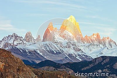 First rays of sun at sunrise over Mount Fitz Roy or Cerro Chalten, Argentina Stock Photo