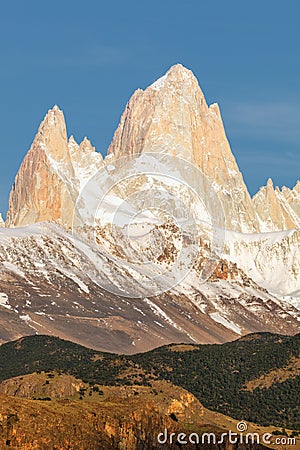 First rays of sun at sunrise over Mount Fitz Roy or Cerro Chalten. Chile Stock Photo