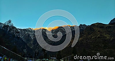 First rays of sunshine over mountains at Lachung Sikkim . Stock Photo