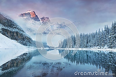 First snow Morning at Moraine Lake in Banff National Park Alberta Canada. Snow-covered winter mountain lake in a winter atmosphere Stock Photo