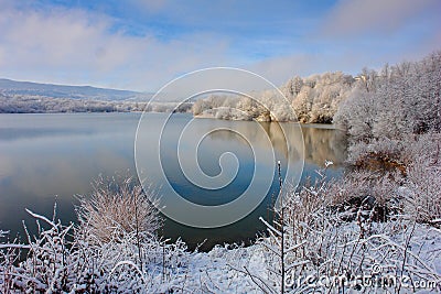 The first snow on a mountain lake Stock Photo