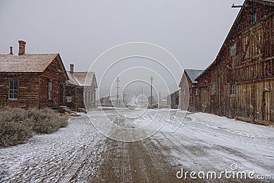 First snow of the winter covering the old wooden mining town in California. Stock Photo