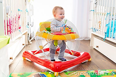 First steps in a baby walker Stock Photo