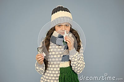 First symptoms of virus. kid treat runny nose with nasal spray. free your stuffy nose. no addiction to medicals. small Stock Photo