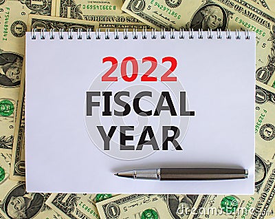 2022 fiscal new year symbol. White note with words 2022 fiscal year on beautiful white background, dollar bills, metallic pen. Stock Photo