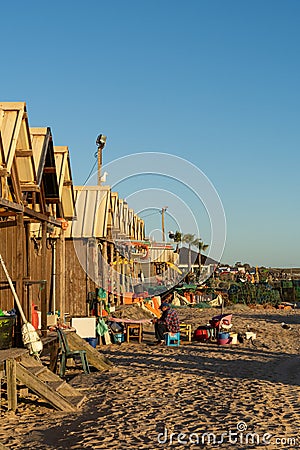 Fiserman sitting outside his hut at sunset and repairing his nets Editorial Stock Photo