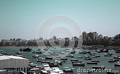 Fish boats parking near the Citadel of Qaitbay on the coast of Alexanderia Editorial Stock Photo