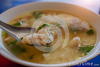 Fish boiled rice is a popular food eaten in the morning to make it feel easy to digest, Breakfast is fish porridge against a blurr Stock Photo