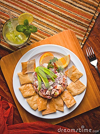 Fish ceviche with avocado, tortilla chips and a mojito Stock Photo