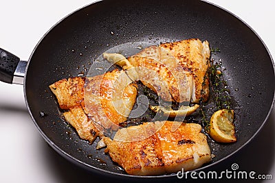 Fish cooking in frying pan Stock Photo