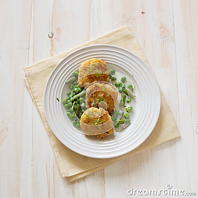 Fish cutlets with green peas and beans Stock Photo
