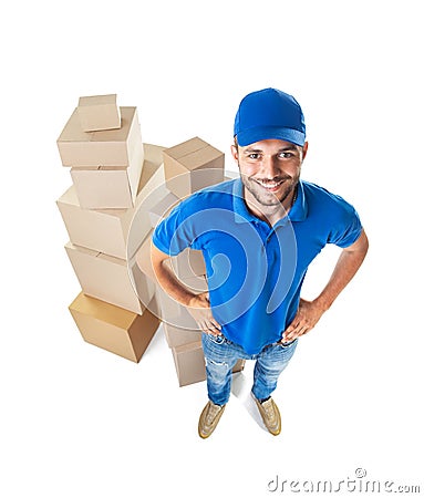 Fish eye shot of smiling courier with stack of cardboard boxes Stock Photo