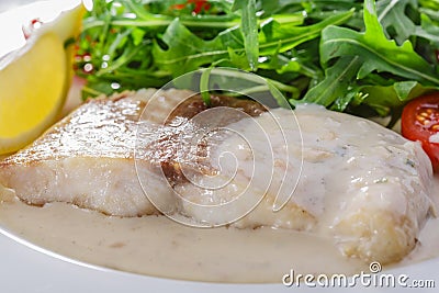 Fish fillet in white sauce Stock Photo