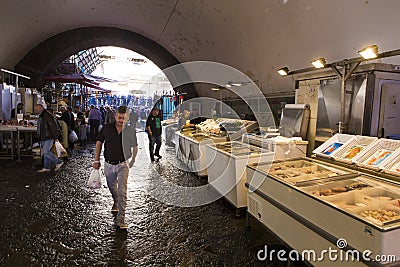 Local people and tourists buying fresh fish on a fish market Editorial Stock Photo