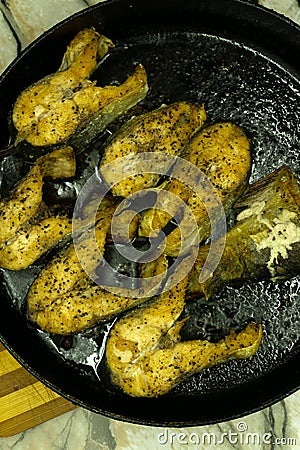 Fish patty cakes are deep frying in the vegetable oil Stock Photo