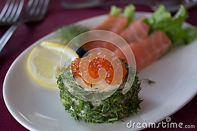 Fish snack with red caviar at restaurant. Stock Photo