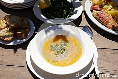 Fish soup dish from red scorpionfish, bread, greens salad in the greek tavern, healthy seafood lunch concept. Stock Photo