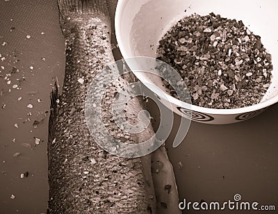 Fish and spices on a plastic cutting board. Fish in the process Stock Photo