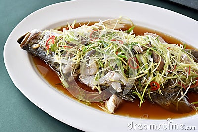 Fish steamed in soy sauce, Snapper boiled with ginger and spring onion sliced. Stock Photo