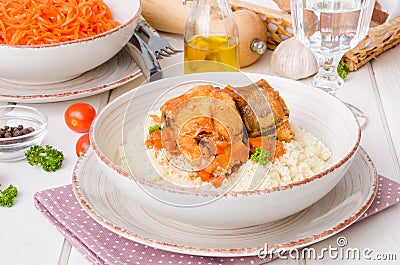 Fish stewed in tomato sauce with vegetables Stock Photo