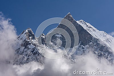 Fish Tail Summit also Machapuchare surrounded by rising clouds Stock Photo