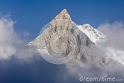 Fish Tail Summit Machapuchare surrounded by rising clouds in Himalayas Stock Photo