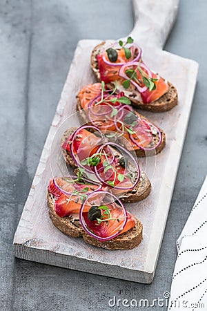 Fish Tapas on wooden board Stock Photo