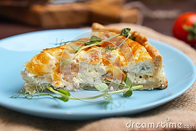 Fish tart. Piece of french pie with salmon and cheese. Quiche lauren with red fish cut off piece Stock Photo