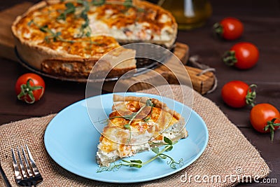 Fish tart. Piece of french pie with salmon and cheese. Quiche lauren with red fish cut off piece Stock Photo