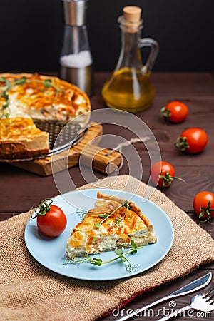 Fish tart. Piece of french pie with salmon and cheese. Quiche lauren with red fish cut off piece Stock Photo