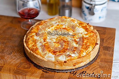 Fish tart. Piece of french pie with salmon and cheese. Quiche lauren with red fish on cutting board Stock Photo