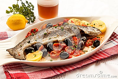 Fish with tomatoes and olives Stock Photo