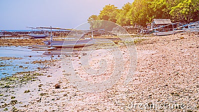 Fisher Boats at low tide near seaweed plantations algal by noon - Nusa Penida, Bali, Indonesia Stock Photo