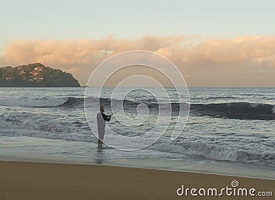 Fisher man Fishing with Spinning Rod in Mexican Beach. Stock Photo