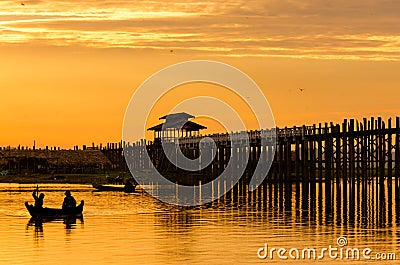 Fisher man at Ubein Bridge at sunset, Mandalay, Myanmar. Stock Photo